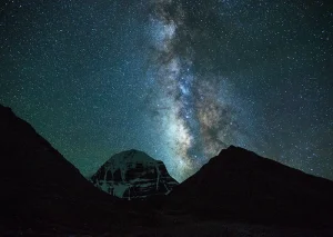 A serene night scene featuring the majestic Mount Kailash under a blanket of stars and the Milky Way.