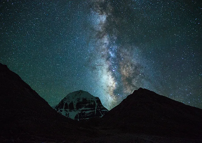 A serene night scene featuring the majestic Mount Kailash under a blanket of stars and the Milky Way.